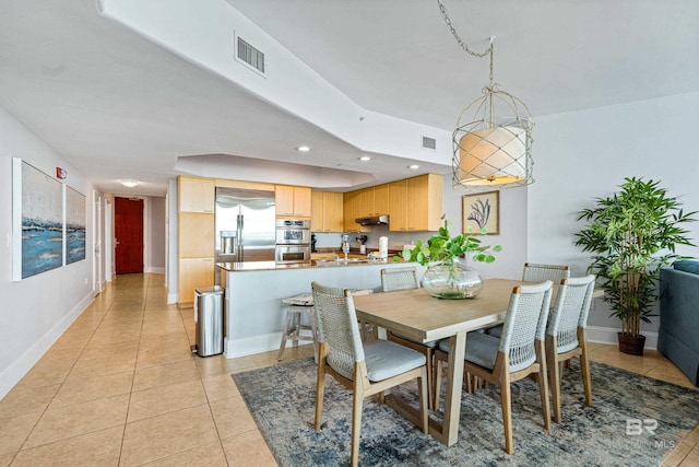 dining area with light tile patterned flooring and sink