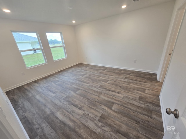 spare room with dark wood-style floors, baseboards, and recessed lighting