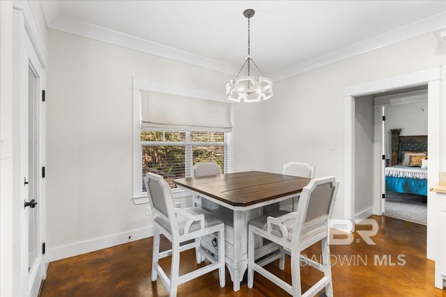 dining space featuring crown molding and a chandelier