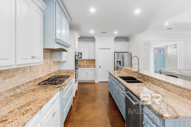 kitchen featuring light stone countertops, sink, stainless steel appliances, tasteful backsplash, and white cabinets