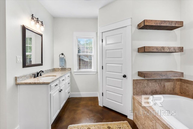 bathroom with vanity, concrete floors, and a relaxing tiled tub