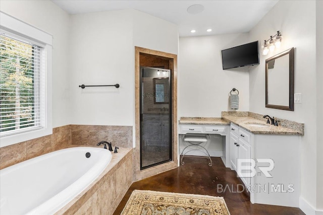 bathroom featuring hardwood / wood-style floors, vanity, a healthy amount of sunlight, and separate shower and tub