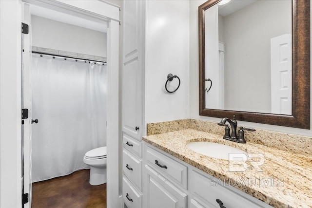 bathroom featuring vanity, toilet, and concrete flooring