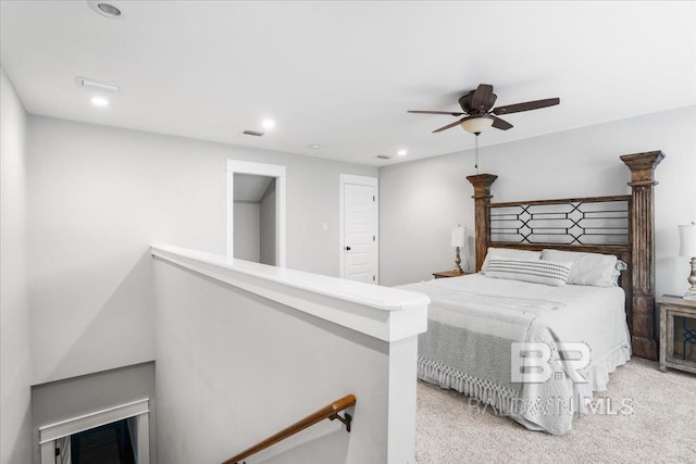 bedroom with ceiling fan and light carpet