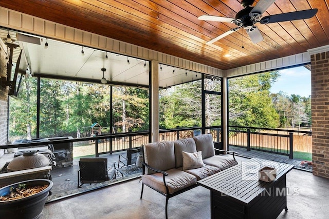 sunroom / solarium with ceiling fan and wooden ceiling