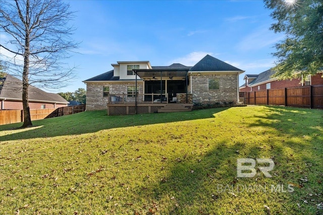 back of house featuring a yard and a deck