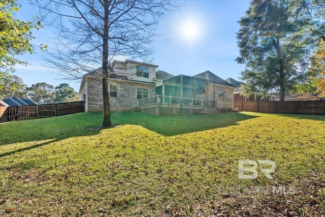 back of house with a sunroom and a lawn