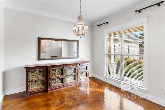 living room featuring crown molding and a chandelier