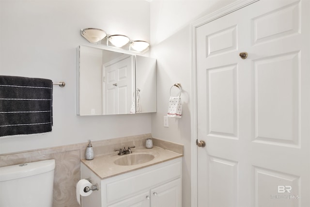 bathroom with toilet and vanity
