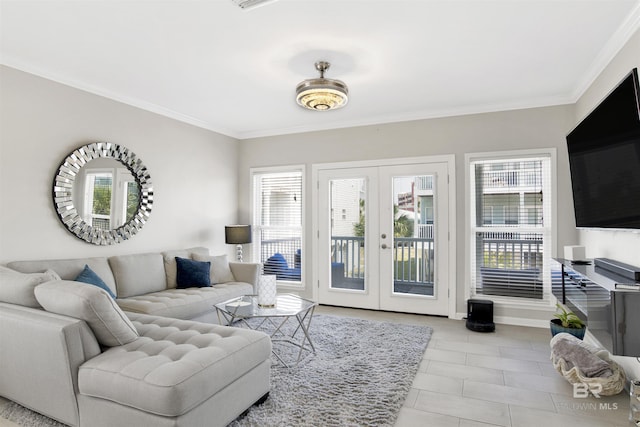 living area with french doors, light tile patterned flooring, crown molding, and baseboards