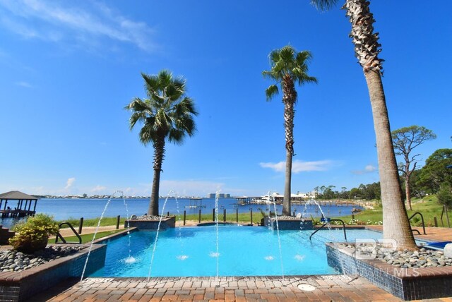 pool featuring a patio and a hot tub