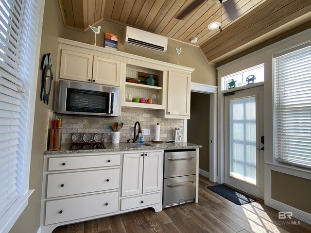 kitchen featuring stainless steel microwave, a wall mounted AC, dark wood-style floors, open shelves, and decorative backsplash