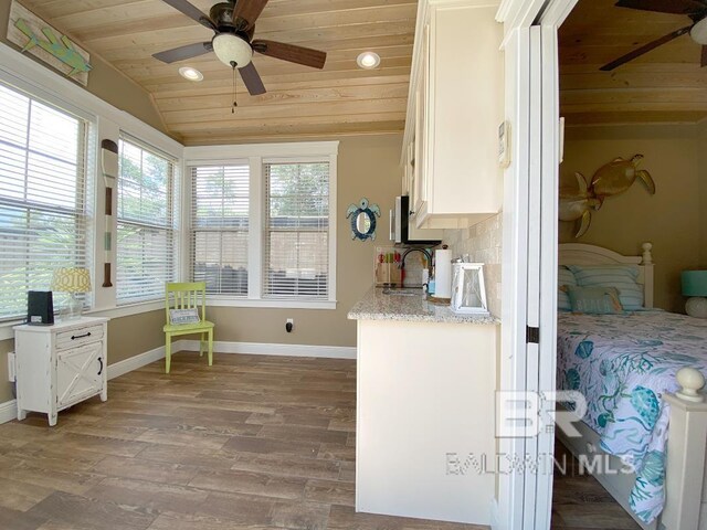 bedroom featuring a ceiling fan, a wall mounted AC, lofted ceiling, and wood ceiling