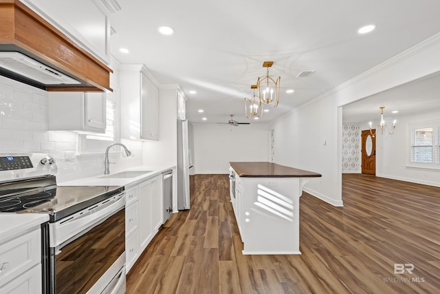 kitchen with appliances with stainless steel finishes, white cabinets, and a sink