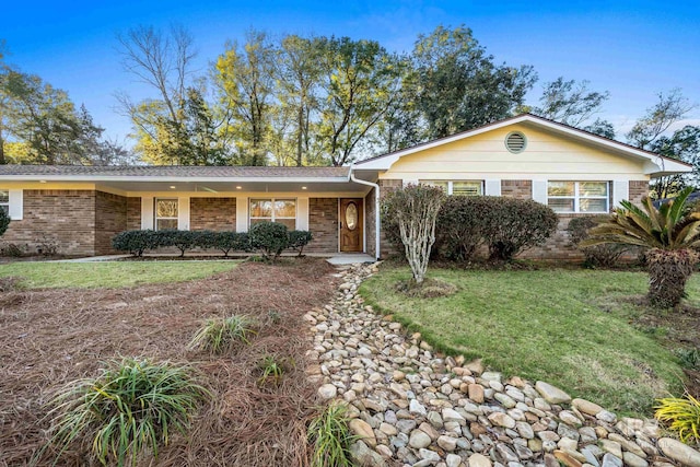 view of front of house with a front lawn and brick siding