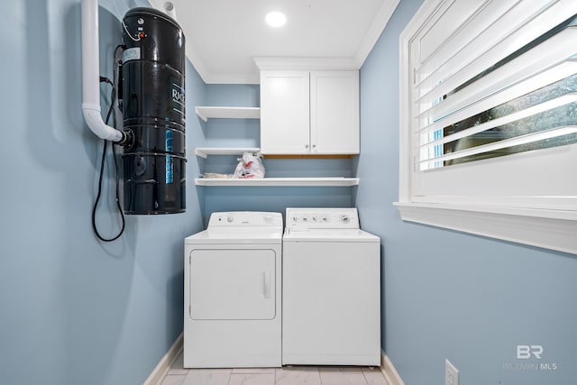 clothes washing area with cabinet space, baseboards, marble finish floor, and washing machine and clothes dryer