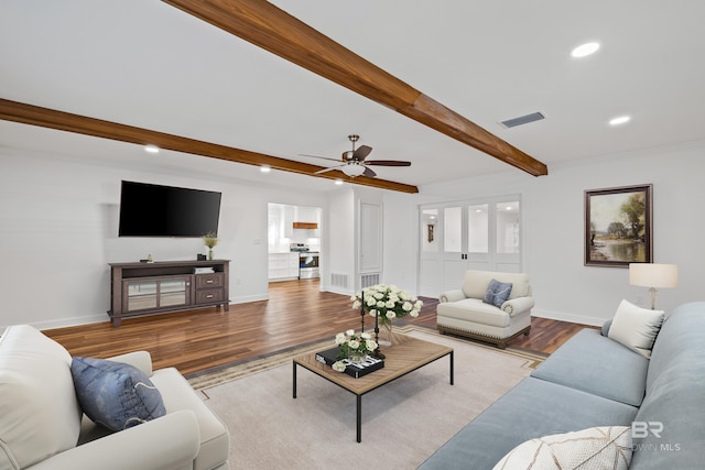 living area with recessed lighting, wood finished floors, visible vents, baseboards, and beam ceiling