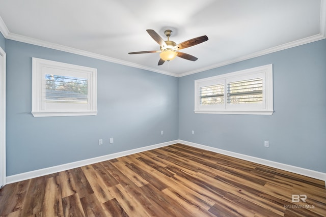 empty room with dark wood-style floors, crown molding, baseboards, and ceiling fan