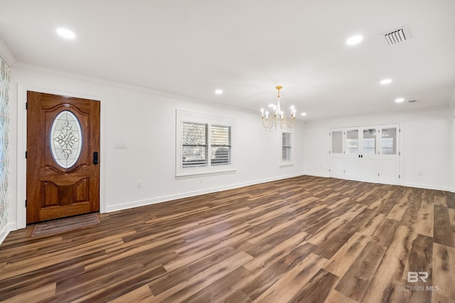 entryway with ornamental molding, dark wood-type flooring, visible vents, and recessed lighting