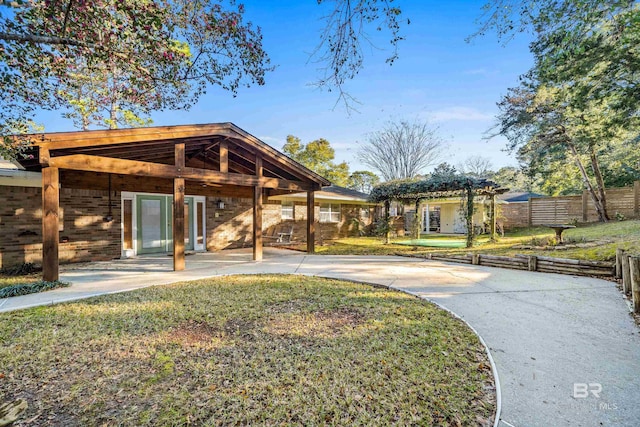 view of home's community with a patio, a lawn, and fence