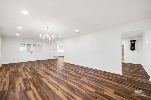 unfurnished living room with ornamental molding, dark wood finished floors, visible vents, and a notable chandelier