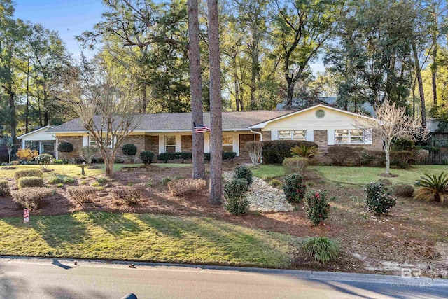 ranch-style home featuring a front yard