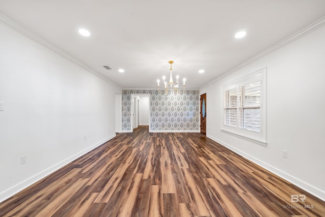 spare room featuring a chandelier, visible vents, crown molding, and baseboards