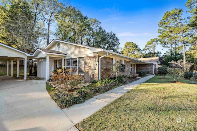 single story home with a carport, concrete driveway, a front yard, and brick siding