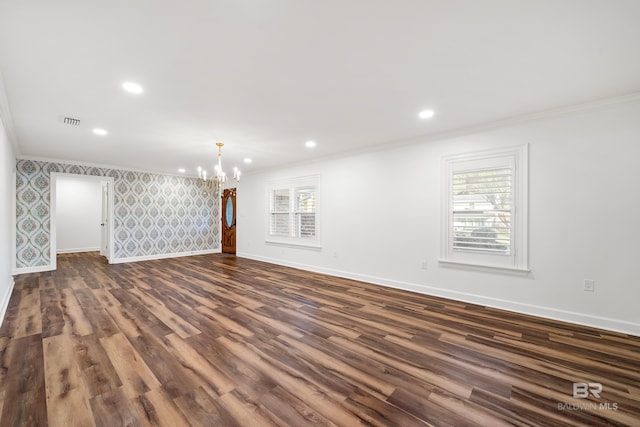 unfurnished room featuring ornamental molding, a healthy amount of sunlight, baseboards, and wallpapered walls