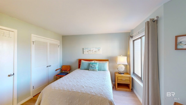 bedroom featuring light wood-type flooring and a closet