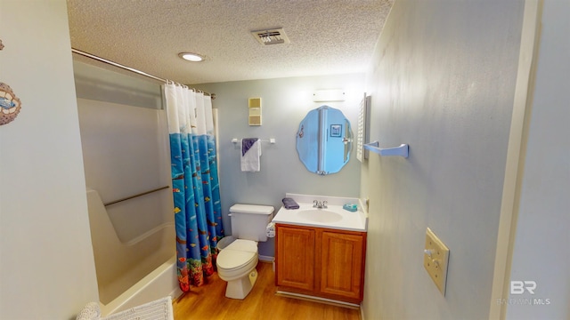 full bathroom with toilet, hardwood / wood-style flooring, shower / bath combination with curtain, a textured ceiling, and vanity