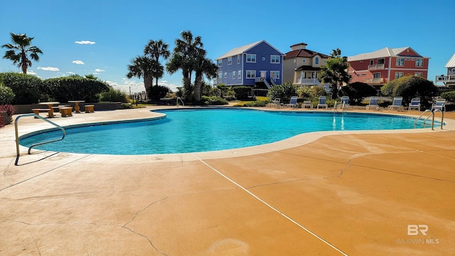 view of swimming pool with a patio