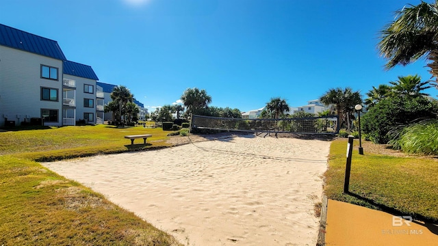 surrounding community featuring volleyball court and a yard