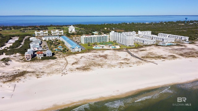 birds eye view of property featuring a water view and a beach view