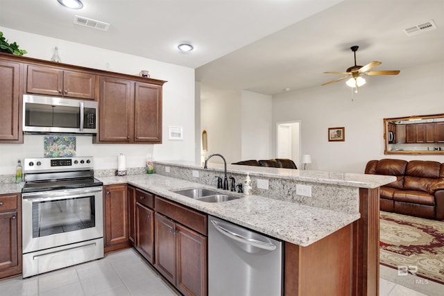 21105 Zinfandel Ln, Silverhill, AL 36576 - kitchen featuring visible vents, a sink, open floor plan, appliances with stainless steel finishes, and a peninsula