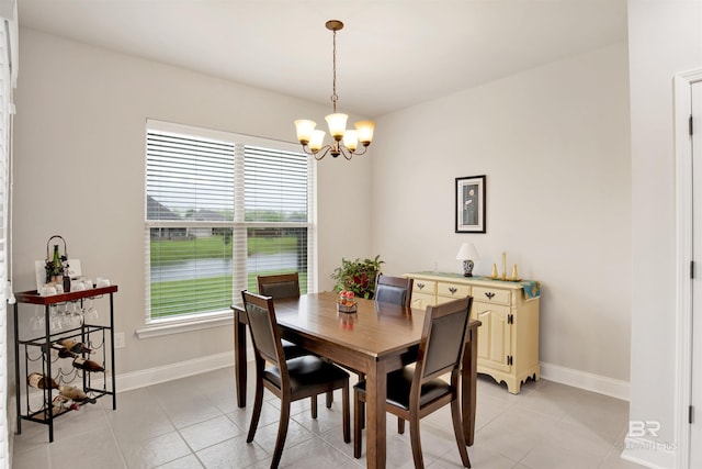 21105 Zinfandel Ln, Silverhill, AL 36576 - dining space featuring baseboards, an inviting chandelier, and light tile patterned flooring