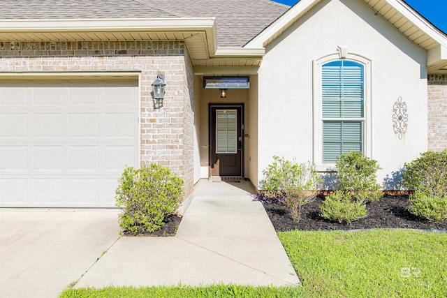 21105 Zinfandel Ln, Silverhill, AL 36576 - property entrance with brick siding, stucco siding, an attached garage, and a shingled roof