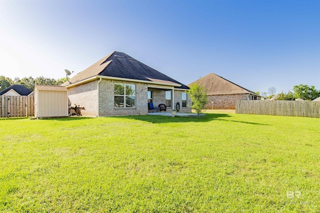 21105 Zinfandel Ln, Silverhill, AL 36576 - rear view of house with a shed, a patio area, a lawn, a fenced backyard, and an outdoor structure
