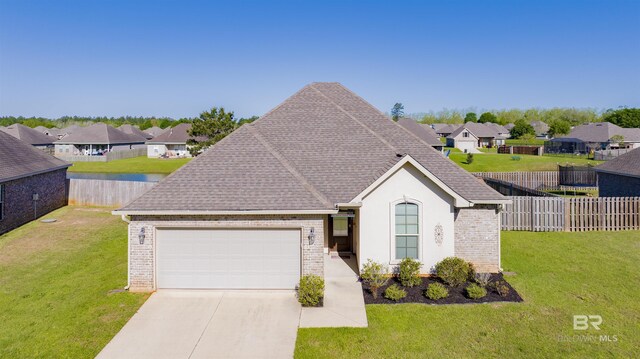 21105 Zinfandel Ln, Silverhill, AL 36576 - view of front of home with an attached garage, concrete driveway, a front yard, and a residential view