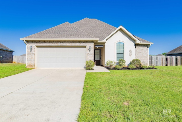 21105 Zinfandel Ln, Silverhill, AL 36576 - ranch-style house featuring a front yard, an attached garage, fence, and concrete driveway