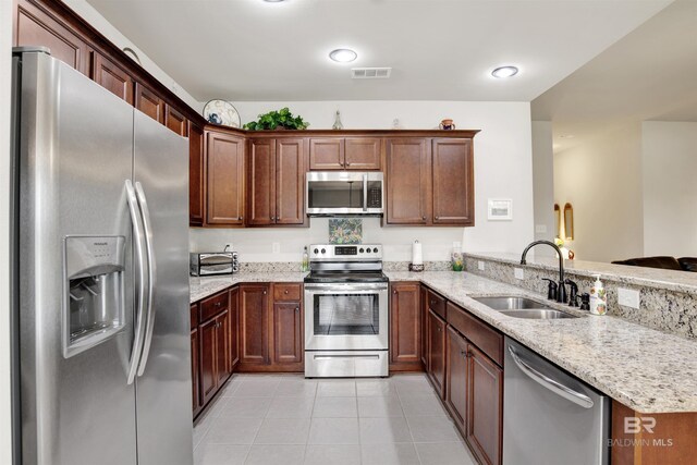 21105 Zinfandel Ln, Silverhill, AL 36576 - kitchen featuring light tile patterned floors, light stone countertops, visible vents, a sink, and stainless steel appliances