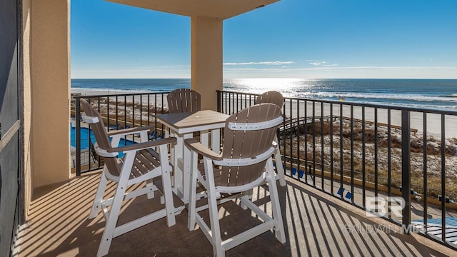 balcony with a beach view and a water view