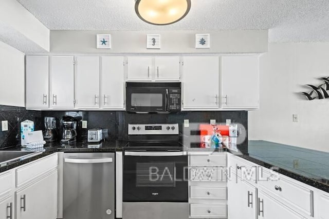 kitchen featuring appliances with stainless steel finishes, dark countertops, white cabinetry, and tasteful backsplash