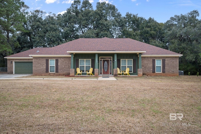 single story home featuring a porch, a garage, and a front yard