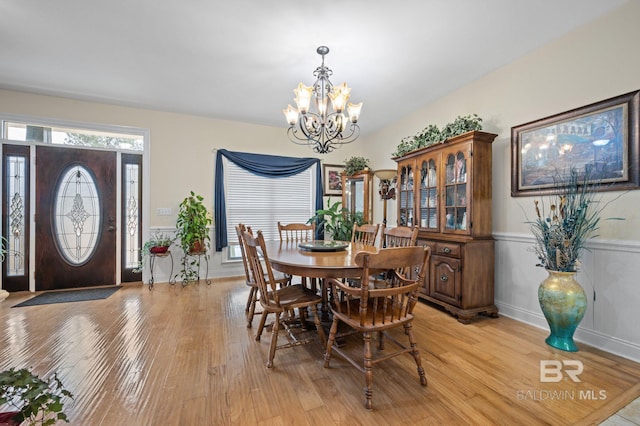 dining room featuring light hardwood / wood-style flooring and a chandelier