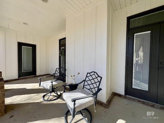 entrance to property with covered porch and board and batten siding