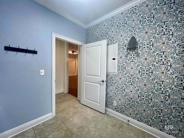 empty room featuring baseboards, ornamental molding, and light tile patterned flooring