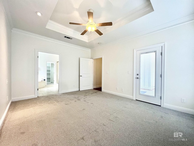 unfurnished bedroom with crown molding, a raised ceiling, visible vents, light carpet, and baseboards