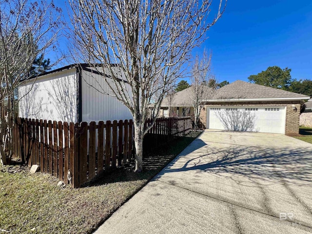 10340 Gayfer Road Ext, Fairhope, AL 36532 - view of property exterior with driveway, a garage, fence, and a shingled roof