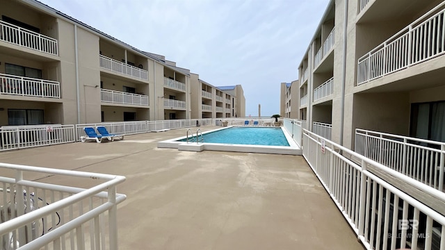 view of swimming pool featuring a patio area